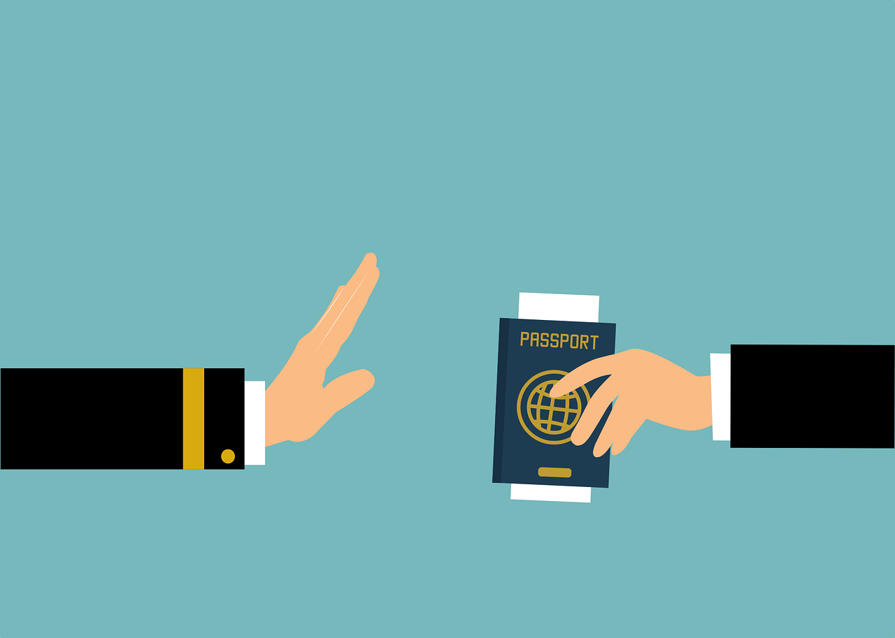 immigration officer hand and traveller's hand holding a passport